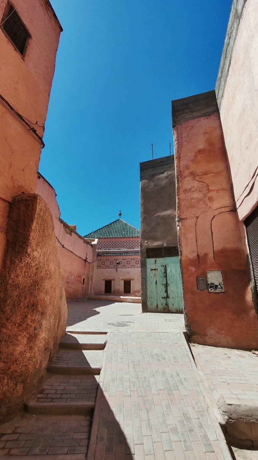 Petite place de la Médina de Marrakech ouvrant sur un toit de tuiles vertes